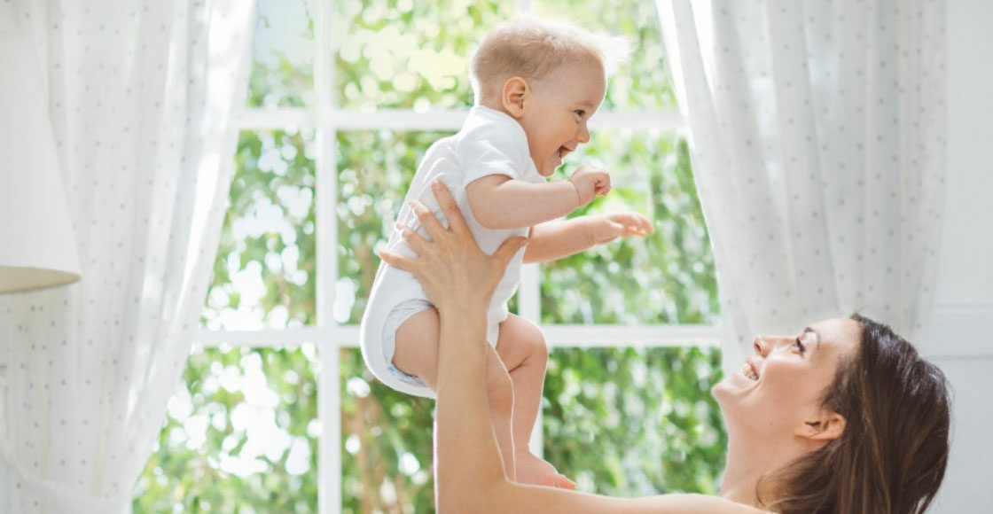 Mom lifting her baby in the air