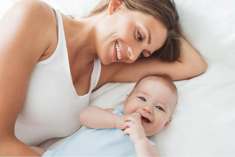 Laughing baby with mom